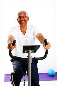 An elderly man on an exercise bike.