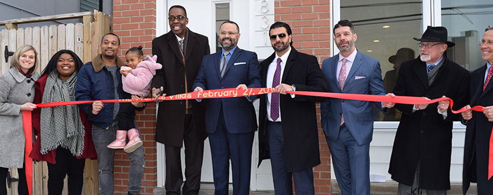 Photograph of developers, city officials, and new residents at the Francis Villas ribbon cutting in 2019.