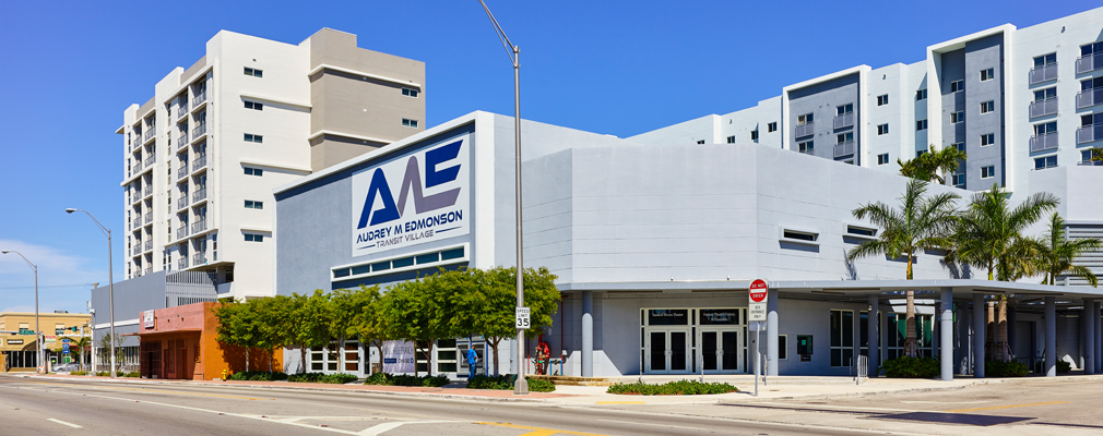 Photograph of AME Transit Village, with the entrance to the Sandrell Rivers Theater in the foreground and two 9-story buildings in the background.