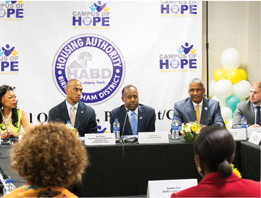 Denise Cleveland-Leggett, Region IV Regional Administrator; Scott Turner, executive director of the White House Opportunity and Revitalization Council; Secretary Ben Carson; and officials from Birmingham, Alabama, are seated around a table.